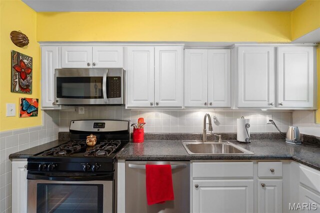 2604 Jonathan Dr, Mehlville, MO 63125 - kitchen with appliances with stainless steel finishes, white cabinets, and dark countertops
