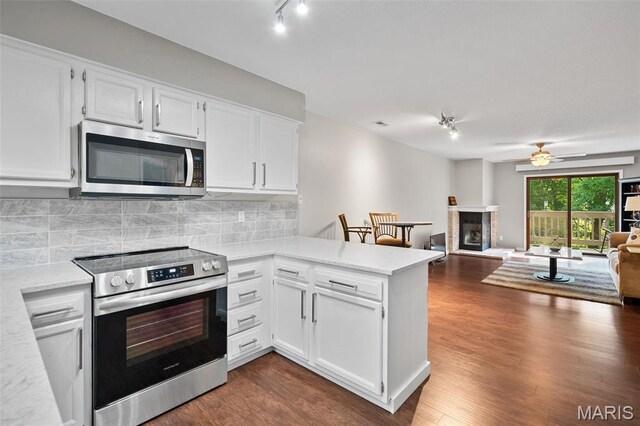 12958 Bryce Canyon Dr Unit C, Maryland Heights, MO 63043 - kitchen featuring stainless steel appliances, a peninsula, track lighting, and white cabinets