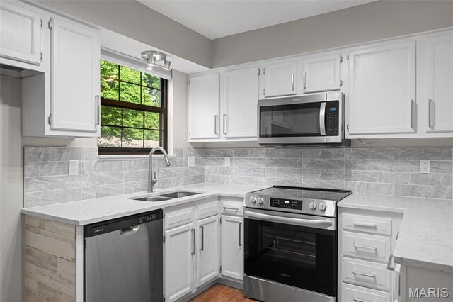 12958 Bryce Canyon Dr Unit C, Maryland Heights, MO 63043 - kitchen with appliances with stainless steel finishes, a sink, white cabinetry, tasteful backsplash, and light stone counters