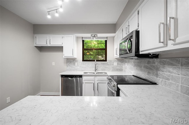 12958 Bryce Canyon Dr Unit C, Maryland Heights, MO 63043 - kitchen with appliances with stainless steel finishes, a sink, white cabinets, and decorative backsplash