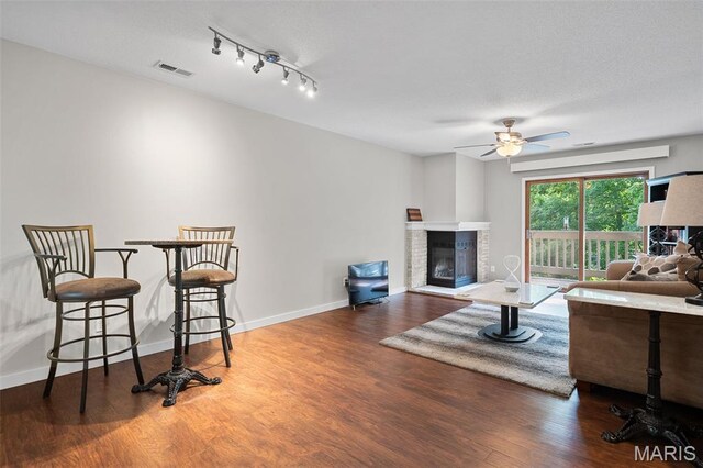 12958 Bryce Canyon Dr Unit C, Maryland Heights, MO 63043 - living room with ceiling fan, a glass covered fireplace, wood finished floors, and baseboards