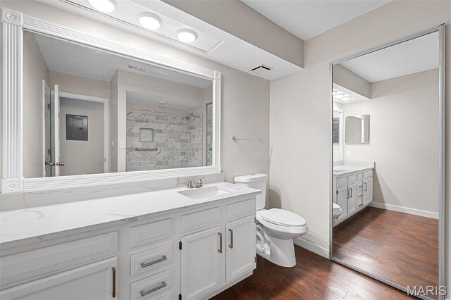 12958 Bryce Canyon Dr Unit C, Maryland Heights, MO 63043 - bathroom with toilet, a tile shower, vanity, and wood finished floors