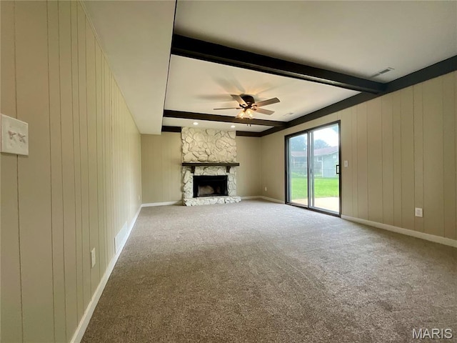 3919 Bellvue Dr, Saint Peters, MO 63376 - unfurnished living room with beamed ceiling, a ceiling fan, carpet floors, a fireplace, and wood walls