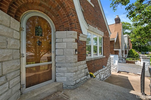 6314 Chippewa St, Saint Louis, MO 63109 - entrance to property with brick siding, a chimney, and stone siding