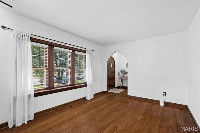 6314 Chippewa St, Saint Louis, MO 63109 - unfurnished room with wood finished floors, arched walkways, and baseboards