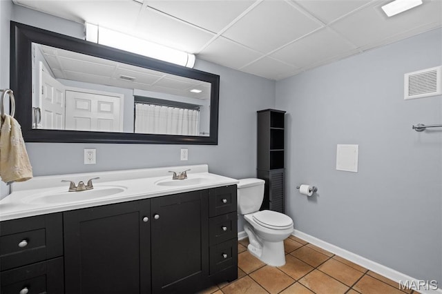 6314 Chippewa St, Saint Louis, MO 63109 - bathroom featuring tile patterned flooring, double vanity, toilet, baseboards, and a drop ceiling