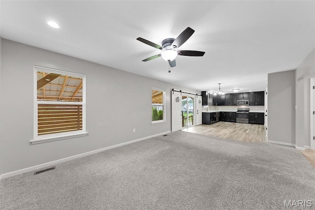 3169 Willow Point Dr, Imperial, MO 63052 - unfurnished living room featuring light colored carpet, a ceiling fan, and recessed lighting