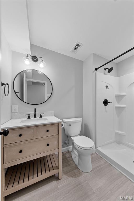 3169 Willow Point Dr, Imperial, MO 63052 - full bathroom with vanity, a shower, and wood finished floors
