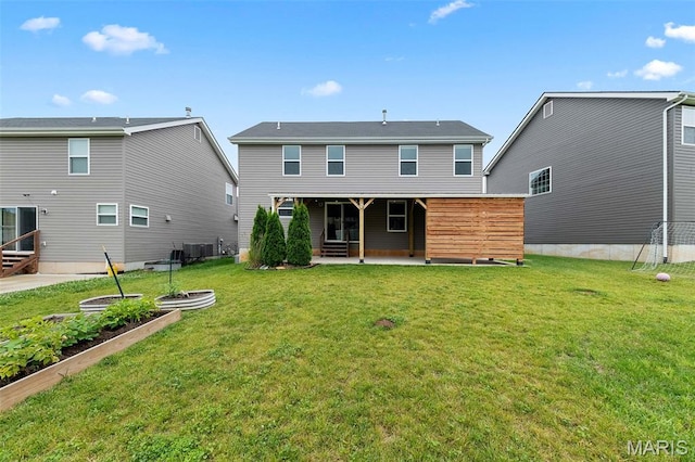 3169 Willow Point Dr, Imperial, MO 63052 - back of house featuring a patio, a vegetable garden, entry steps, and a lawn