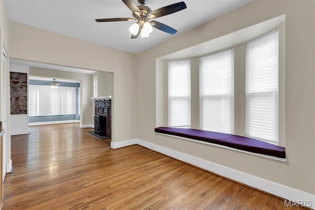 6026 Waterman Ave Unit 3E, Saint Louis, MO 63112 - unfurnished living room featuring light wood-type flooring, ceiling fan, and baseboards