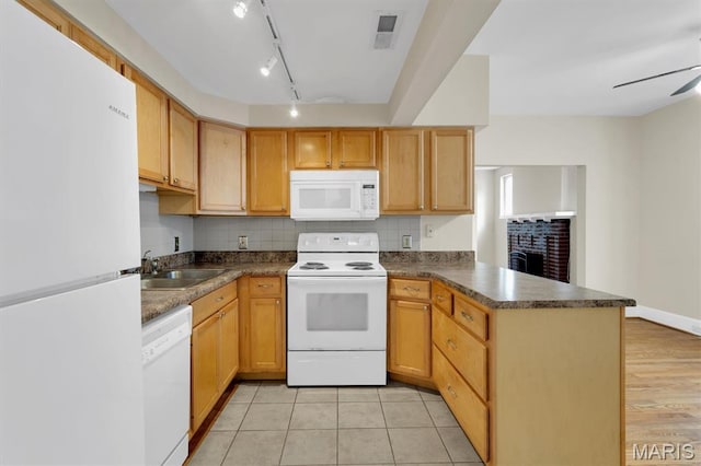 6026 Waterman Ave Unit 3E, Saint Louis, MO 63112 - kitchen with white appliances, a peninsula, dark countertops, and backsplash