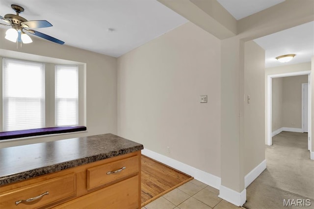 6026 Waterman Ave Unit 3E, Saint Louis, MO 63112 - kitchen featuring dark countertops, ceiling fan, baseboards, and light tile patterned flooring