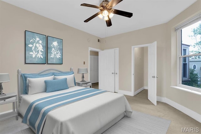 6026 Waterman Ave Unit 3E, Saint Louis, MO 63112 - bedroom featuring light colored carpet, baseboards, and a ceiling fan