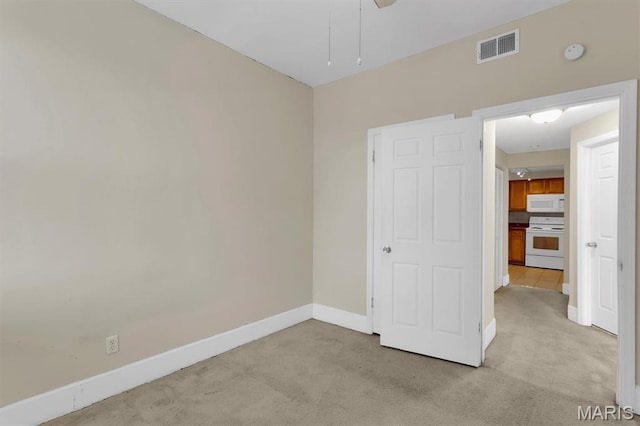 6026 Waterman Ave Unit 3E, Saint Louis, MO 63112 - unfurnished bedroom with baseboards, light colored carpet, and a ceiling fan