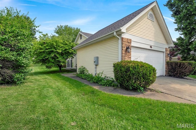 1045 Sprinters Row Dr, Florissant, MO 63034 - view of home's exterior with a lawn, driveway, an attached garage, brick siding, and roof with shingles