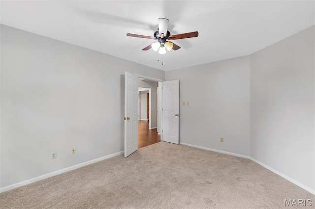 1045 Sprinters Row Dr, Florissant, MO 63034 - empty room featuring light carpet, ceiling fan, and baseboards
