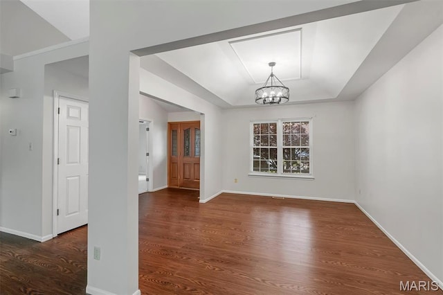 1045 Sprinters Row Dr, Florissant, MO 63034 - unfurnished dining area with a tray ceiling, a chandelier, wood finished floors, and baseboards