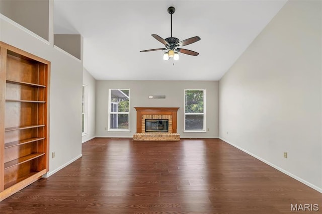 1045 Sprinters Row Dr, Florissant, MO 63034 - unfurnished living room featuring dark wood-style flooring, a ceiling fan, built in shelves, baseboards, and vaulted ceiling