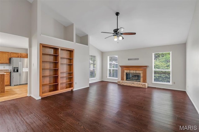 1045 Sprinters Row Dr, Florissant, MO 63034 - unfurnished living room featuring a ceiling fan, a fireplace, high vaulted ceiling, baseboards, and dark wood-style flooring