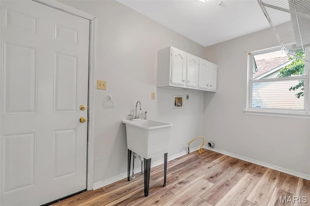 1045 Sprinters Row Dr, Florissant, MO 63034 - laundry room featuring cabinet space, washer hookup, light wood finished floors, and baseboards