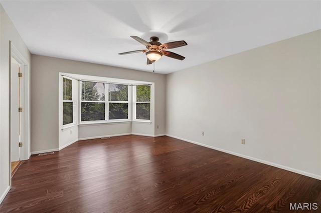 1045 Sprinters Row Dr, Florissant, MO 63034 - spare room with a ceiling fan, dark wood-type flooring, and baseboards