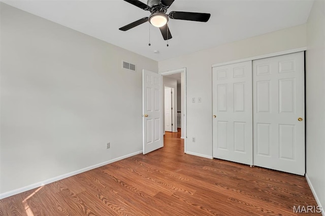 1045 Sprinters Row Dr, Florissant, MO 63034 - unfurnished bedroom with baseboards, wood finished floors, a closet, and a ceiling fan