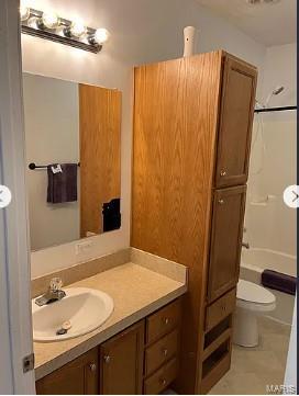 876 Mildred Ave, Cahokia, IL 62206 - full bathroom with vanity, toilet,  shower combination, and tile patterned flooring
