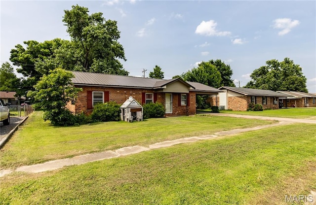 141 Saint Catherine Ln, New Madrid, MO 63869 - ranch-style home with driveway and brick siding