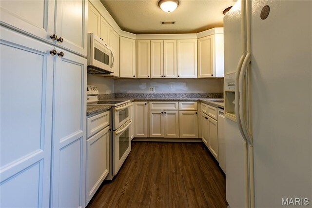 141 Saint Catherine Ln, New Madrid, MO 63869 - kitchen featuring white appliances, dark wood-style floors, white cabinets, and stone countertops