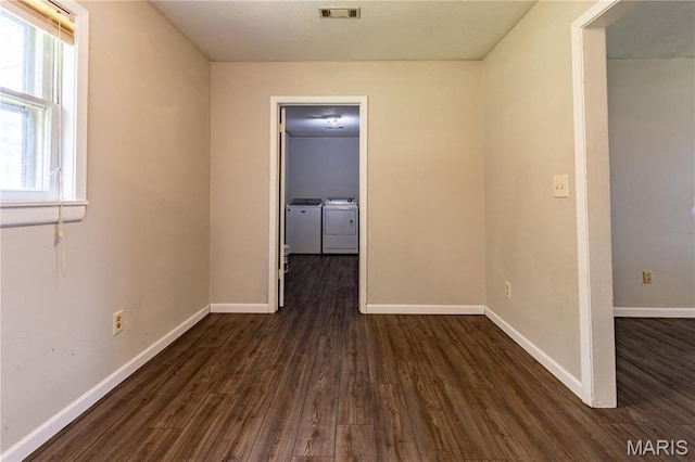 141 Saint Catherine Ln, New Madrid, MO 63869 - empty room featuring separate washer and dryer, dark wood-style flooring, baseboards, and healthy amount of natural light
