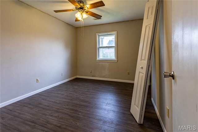 141 Saint Catherine Ln, New Madrid, MO 63869 - spare room featuring dark wood-style flooring, ceiling fan, and baseboards