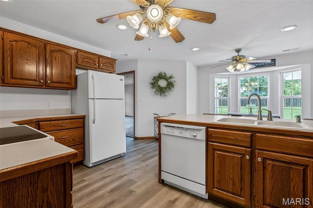 303 Chadrick Dr, Desloge, MO 63601 - kitchen featuring white appliances, a sink, light wood-style flooring, brown cabinets, and recessed lighting