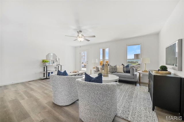 3064 Pirogue St, Saint Charles, MO 63301 - living room featuring light wood-style floors, ceiling fan, and baseboards
