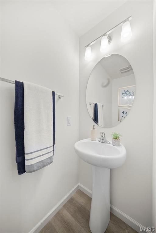 3064 Pirogue St, Saint Charles, MO 63301 - bathroom with wood finished floors, baseboards, and a sink