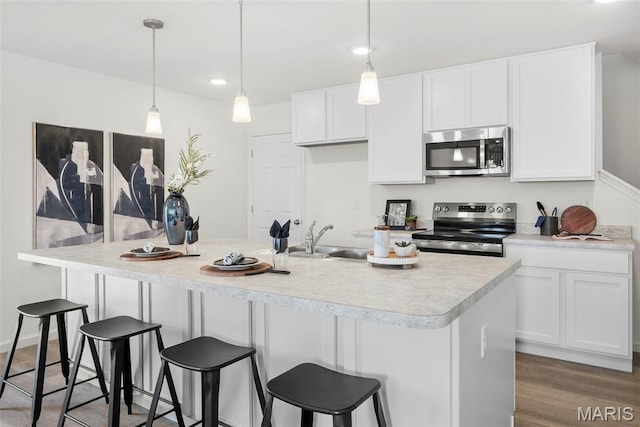 3064 Pirogue St, Saint Charles, MO 63301 - kitchen featuring stainless steel microwave, electric stove, a sink, white cabinets, and light countertops