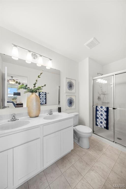 3064 Pirogue St, Saint Charles, MO 63301 - ensuite bathroom with double vanity, a shower stall, ceiling fan, toilet, and tile patterned floors