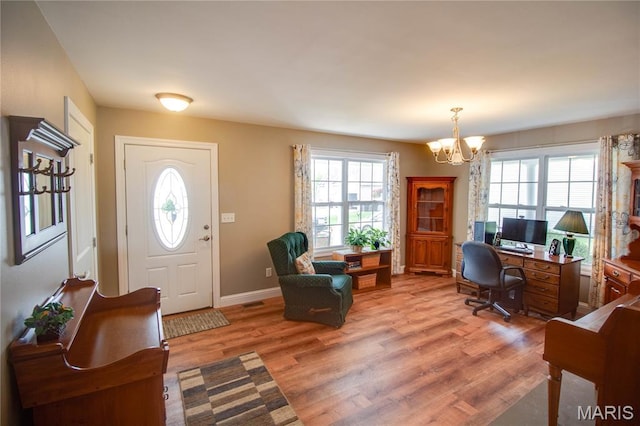 2 Breezeway Ct, Jerseyville, IL 62052 - entryway featuring a chandelier, healthy amount of natural light, light wood-style floors, and baseboards