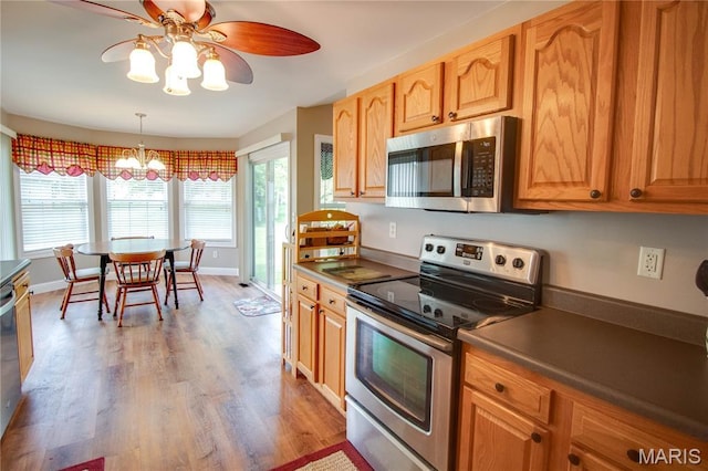 2 Breezeway Ct, Jerseyville, IL 62052 - kitchen with appliances with stainless steel finishes, a ceiling fan, a chandelier, wood finished floors, and dark countertops