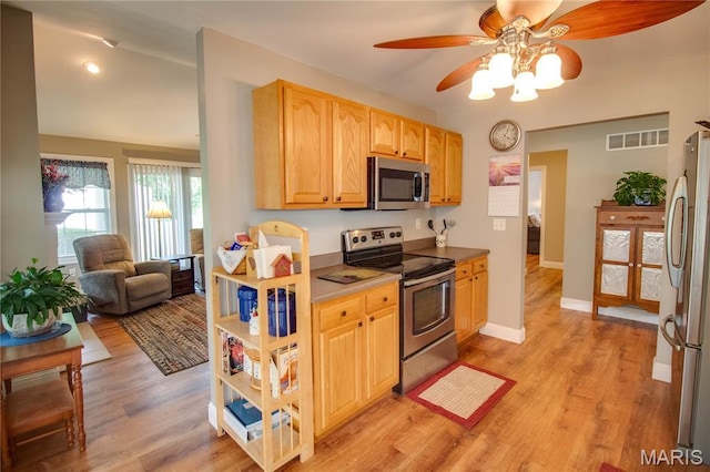 2 Breezeway Ct, Jerseyville, IL 62052 - kitchen featuring appliances with stainless steel finishes, ceiling fan, light wood-style flooring, light brown cabinetry, and baseboards