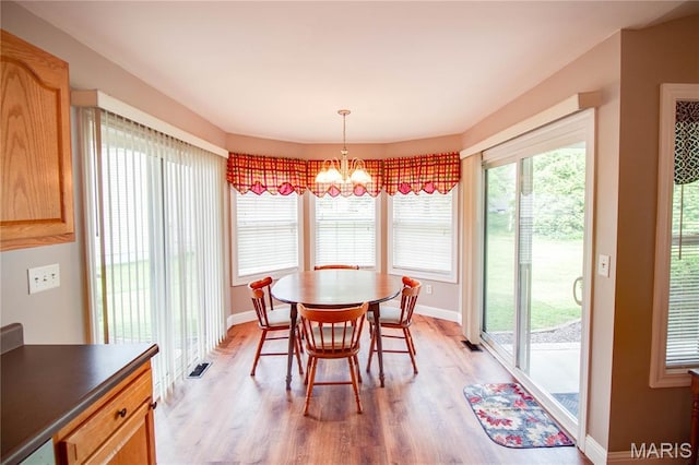 2 Breezeway Ct, Jerseyville, IL 62052 - dining space with a chandelier, light wood-type flooring, and baseboards