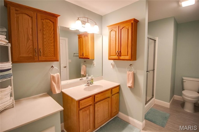 2 Breezeway Ct, Jerseyville, IL 62052 - bathroom featuring toilet, a stall shower, vanity, and wood finished floors