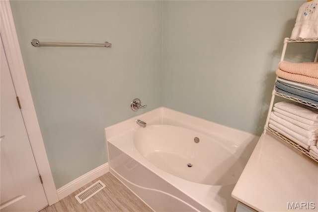 2 Breezeway Ct, Jerseyville, IL 62052 - full bathroom featuring a garden tub, baseboards, and wood finished floors