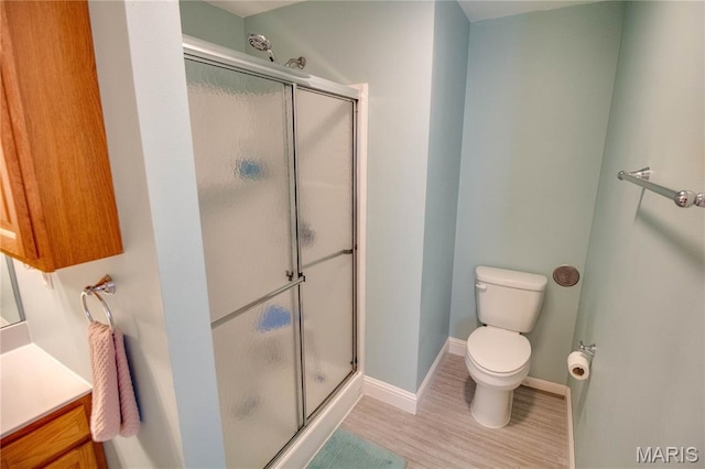 2 Breezeway Ct, Jerseyville, IL 62052 - bathroom featuring a shower stall, wood finished floors, toilet, baseboards, and vanity
