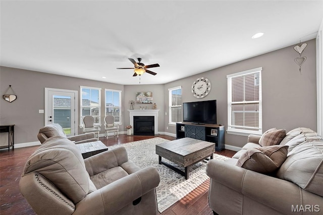 3204 Hadrian St, Saint Charles, MO 63301 - living room featuring a ceiling fan, baseboards, recessed lighting, dark wood-style floors, and a glass covered fireplace