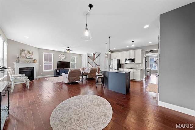 3204 Hadrian St, Saint Charles, MO 63301 - living area featuring ceiling fan, stairway, a fireplace, baseboards, and recessed lighting