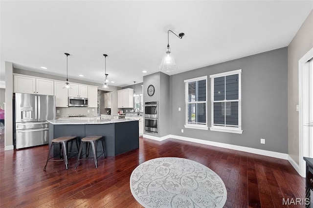 3204 Hadrian St, Saint Charles, MO 63301 - kitchen with appliances with stainless steel finishes, a sink, white cabinets, baseboards, and recessed lighting