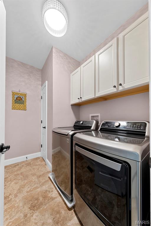 3204 Hadrian St, Saint Charles, MO 63301 - laundry area featuring cabinet space, separate washer and dryer, and baseboards