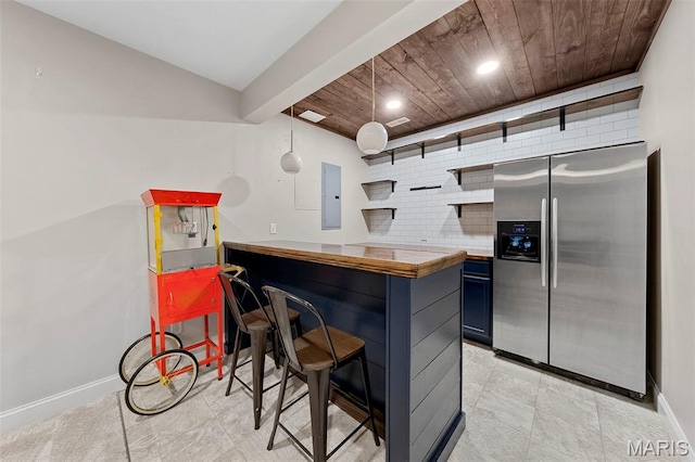 3204 Hadrian St, Saint Charles, MO 63301 - kitchen featuring stainless steel fridge with ice dispenser, open shelves, electric panel, baseboards, and blue cabinets