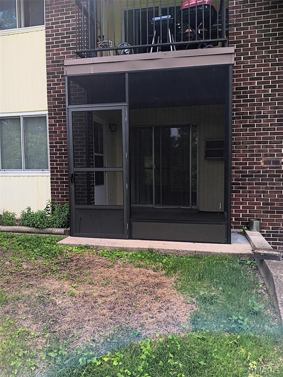 7731 Hazelcrest Dr Unit B, Hazelwood, MO 63042 - doorway to property with brick siding and a balcony