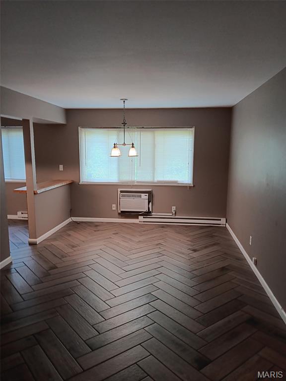 7731 Hazelcrest Dr Unit B, Hazelwood, MO 63042 - spare room featuring baseboards, baseboard heating, and a wall unit AC